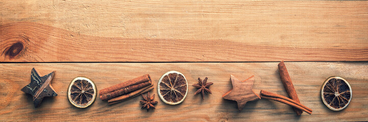 Christmas wooden panoramic background with spices, orange, cinnamon, stars
