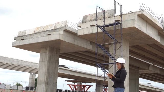 Engineer woman working at site of bridge under construction