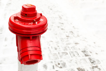 industrial background red hydrant close-up contrasting on a background of snow stone area copy space