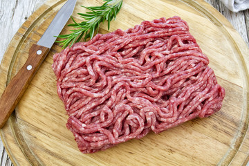 raw minced meat on wooden board