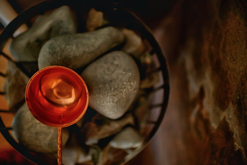 sauna stones / hot stones for water supply, steam on the stones in the sauna, spa concept, hot relaxation