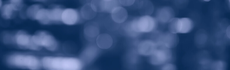 blurred bokeh city background / glare and glowing light in night city, modern beautiful bright background