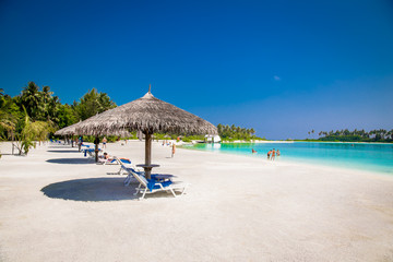 Beautiful beach with white sand at tropical Olhuveli island, Maldives.