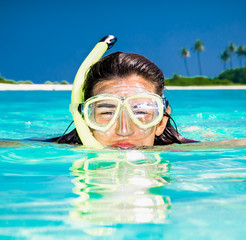 Naklejka premium Happy girl at topical beach on Olhuveli island. Maldives.