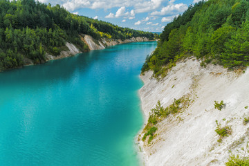 Obraz premium An old gypsum quarry filled with blue and pure water. Aerial view, from top to bottom