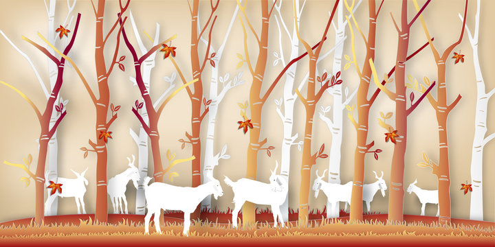Paper art of goats in the autumn season with nature maple leaf and trees background as digital craft style concept. vector illustration © ImagineDesign