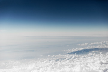 Clouds Building Around Mountains Edge Above Natural Landscape