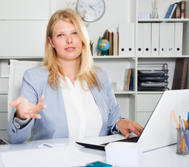 Lady business adviser sitting at workplace