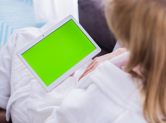 woman is relaxing on comfortable couch and using laptop at home