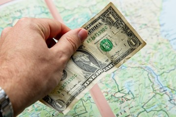 Offshore investing concept image consisting of a USA dollar banknote and a map. 