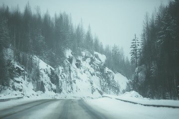 snow and fog on the winter road landscape / view of the seasonal weather a dangerous road, a winter lonely landscape