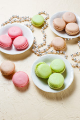 Colourful macaroons on the plates