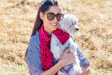 Beautiful Smiling Woman Hugging  Her Cute Havanese Dog with Red Scarf .Fashion for Owner and Dog .