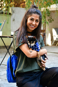 Happy Woman Hugging  Her Cute Chihuahua Mini Dog with Fashion Scarf.Happy Owner and Dog