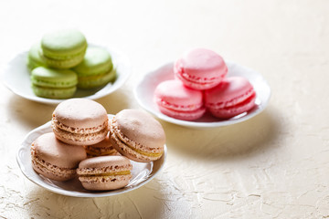 Colourful macaroons on the plates