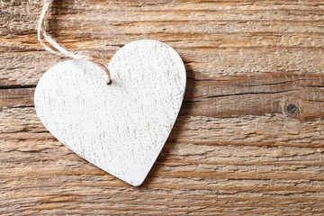 White heart on wooden background