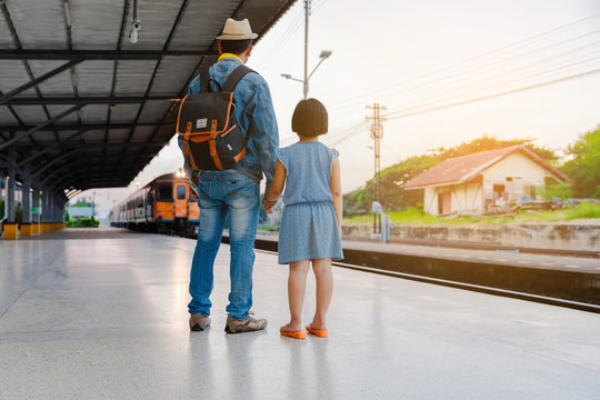 Young and Asian daughters and travelers with backpack in train, backpack and hat at railway station with tourists, travel ideas.
