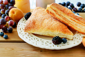 Delicious puff pastry cakes filled with cheese and fruits.