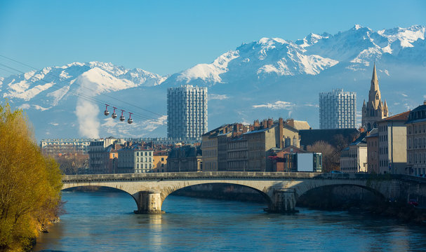Grenoble with cable car against backdrop of snowy Alps