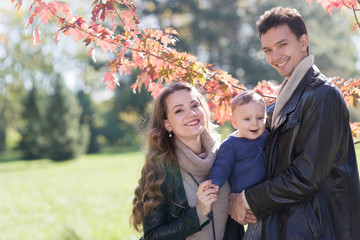 family with a baby in autumn park