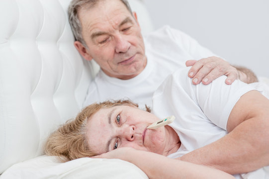 Elderly man takes care of an senior woman