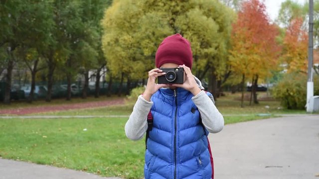 Camera boy. Handsome and cute mixed boy with photo camera. Children are bloggers. Boy making picture of you. 