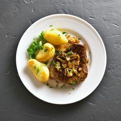 Roasted beef steak with caramelized onion and potatoes