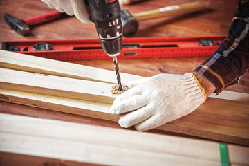 Building DIY with hammer while hit the nail Professional carpenter working with wood and building...