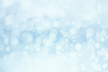 Fototapeta premium Abstract white bokeh on blue background.