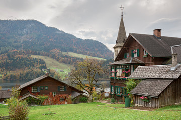 Traditional wooden houses of the town of Grundlsee on a cloudy autumn day. Styria, Austria.