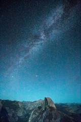 Fototapeta na wymiar Starry night sky with Milky Way above Half Dome peak, Yosemite National Park, USA