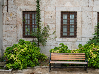 Fototapeta na wymiar wooden bench in a courtyard of historical house