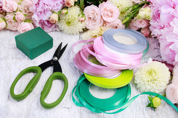 Florist workplace: Rose, lisianthus, dahlia, peony and florist's accessories