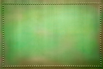 Obraz premium Green metal plate with small rivets.