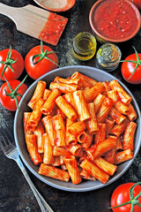 Italian pasta in a bowl with fresh tomato sauce. Vegan bowl with pasta in tomato sauce.