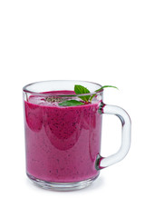 Glass of homemade blueberries smoothie and fresh mint leaf