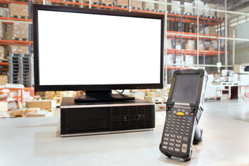 computer with blank screen and a bar code scanner in store warehouse.
