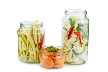 Bean pods, carrot and cauliflower prepared for canning in glass jar
