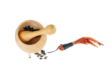 Witchery tools and ingredient: pestle, mortar with grinded beetles and chicken paw charm isolated...