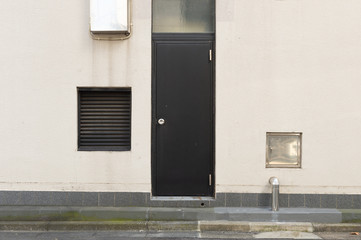 Obraz na płótnie Canvas sidewalk by street wall & door