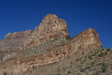 Fototapeta na wymiar Peach Springs, Arizona, USA: Dramatic rock formations against a deep blue sky along Diamond Creek Road, in Peach Springs Canyon, Arizona.