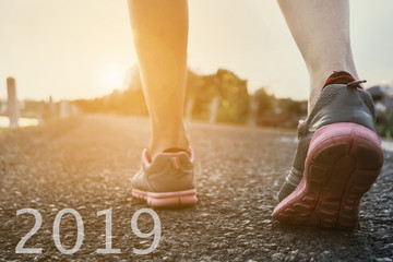 2019 the start into the new year.sports background. legs of runner feet running on road