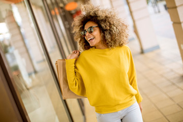 Young black woman with curly hair in shopping