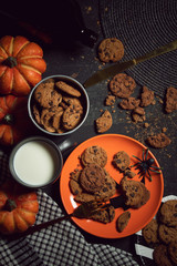 sweet biscuit cookies dessert and milk with halloween holiday dinner prop decoration with wood table background