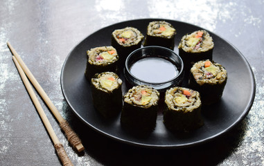 Sushi from cauliflower, avocado, tuna and carrots. Traditional Asian food. Diet healthy food concept. Cereals free. Gluten free. Dairy free. AIP Autoimmune Paleo. Copy space for text.