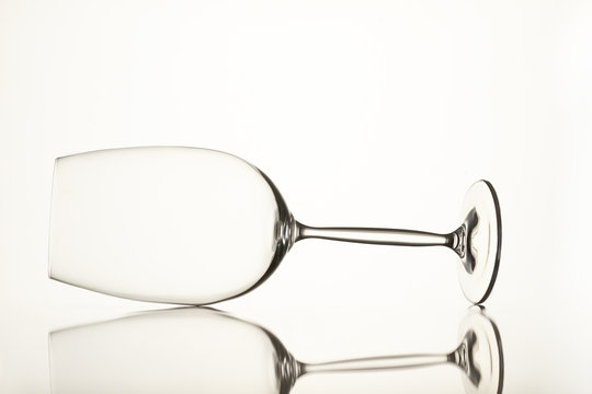 Two empty glass cups, horizontal view. Isolated white background.