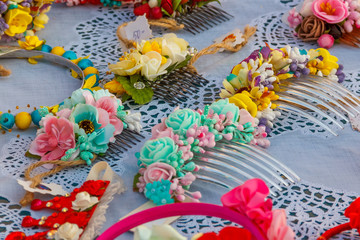 Obraz na płótnie Canvas Combs decorated with artificial flowers on a table