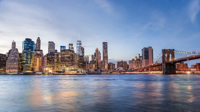 4k cinemagraph of New York City Manhattan, financial district night skyline, cityscape at Brooklyn bridge park during sunset, dusk, twilight, blue hour, skyscrapers, moving clouds, light streaks