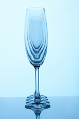 Glass champagne cups in a row. Side view. Visual effect, light deformation.
