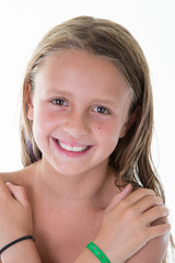 Smiling beauty child girl with crossed arms looking at the camera over white background